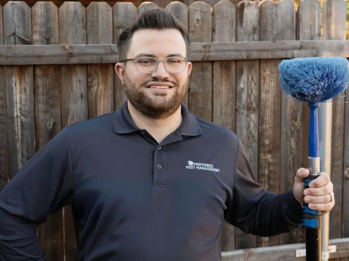 Preferred Pest Management technician in Princeton, TX holding pest control equipment during a service visit